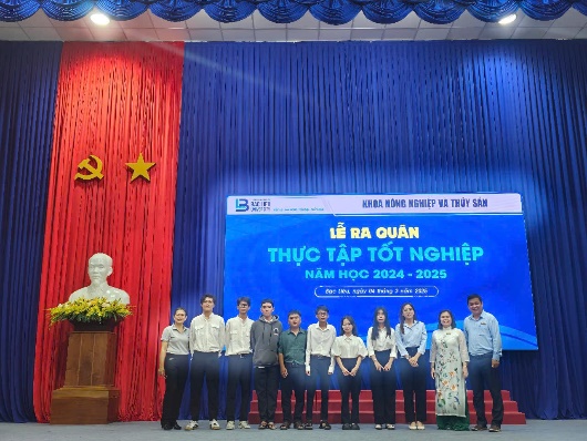 A group of people standing in front of a blue and red curtainAI-generated content may be incorrect.